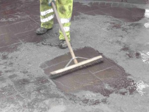 Brushing prior to power washing.